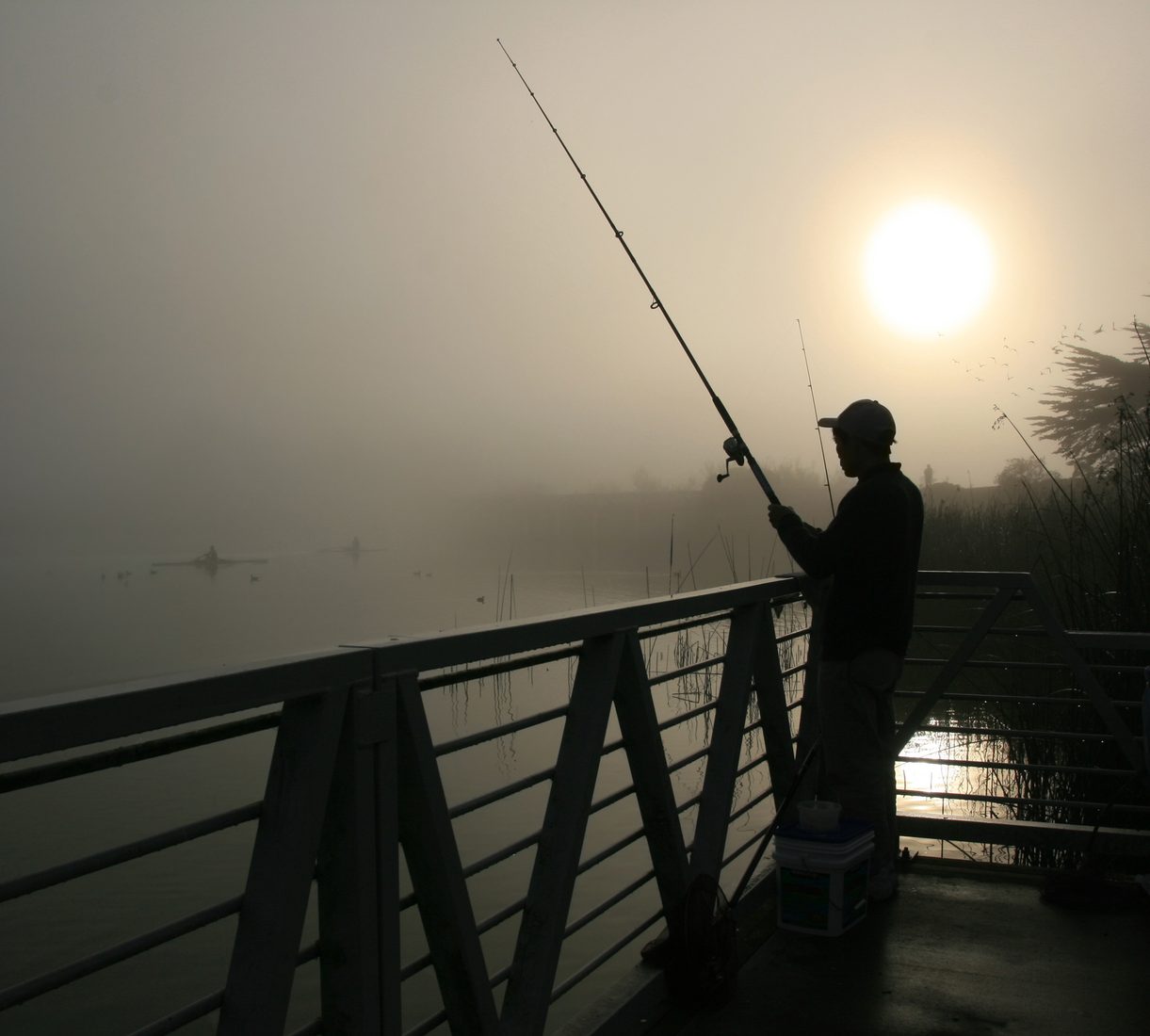 Angler fishing on a quiet lake
